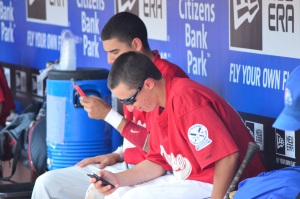 St. Augustine Prep players Mike Elfreth, right, and Christian Adorno text friends while sitting in the dugout at Citizens Bank Park in Philadelphia.