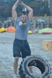 Christian Henchy, a defensive end at Absegami, flips a tire during a drill at Rob Fishbein's Beach Workout Crew workouts.